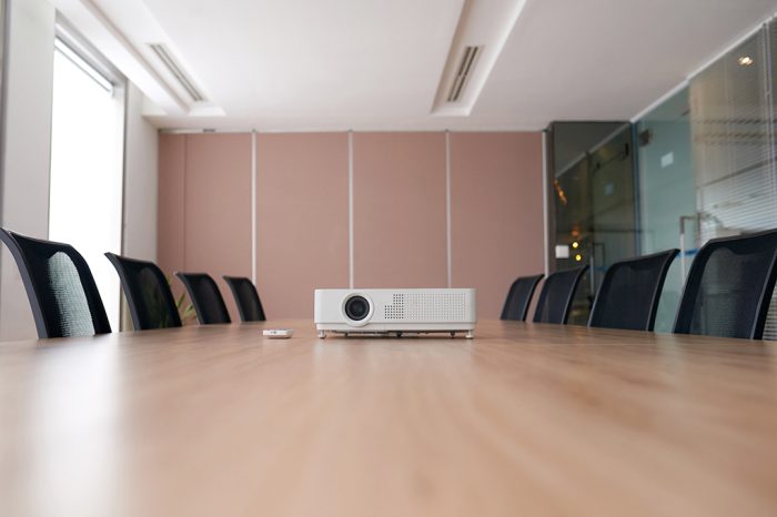 Projector on empty table in meeting room